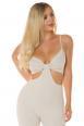 Tuta schiena scoperta con ritagli ai fianchi. Colore beige.