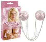 Copricapezzoli rosa con fiocco e fili di perline.
